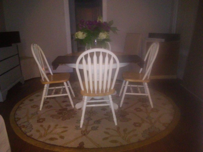 Kitchen table and 4 chairs and rug.