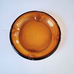 Vintage mid-century glass amber colored ashtray home decor. No chips or cracks. 8" round.