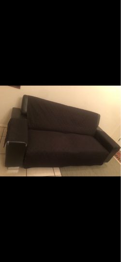 2- identical black sofas w/covers