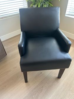 2 black arm chairs