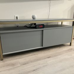 TV Stand About 3 Yrs Old In Very Good Condition Sliding Doors On Front With Shelf Dims. 60x18x24 