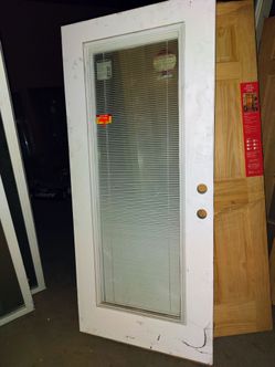 A BRAND NEW ENTRY DOOR W/MINI BLINDS