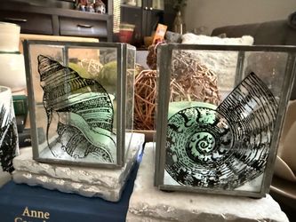 Two's Company Seashell Glass Candle Holders   Decorative glass and metal candle holders from Two's Company. These square lanterns have black seashell 