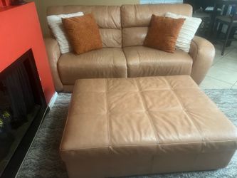 Modern leather loverseat with a matching storage ottoman