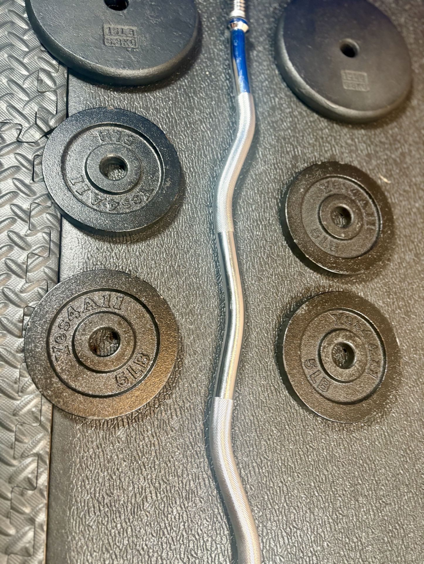 Standard Steel Curl Bar with Cast Iron Weight Plates pairs: 15#, & 4X 5 #. Total: 66 pounds