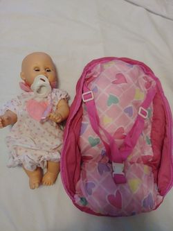 Baby doll with outfit, binky and doll carrier