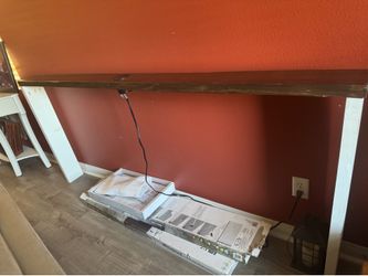 Behind the couch table with outlet