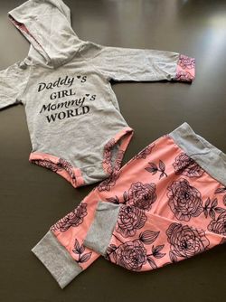 Baby girl outfit: gray hooded romper and pink floral sweatpants, size 3–6 months.