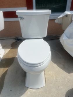 Toilet in good condition and very clean; it measures 17 inches in height.