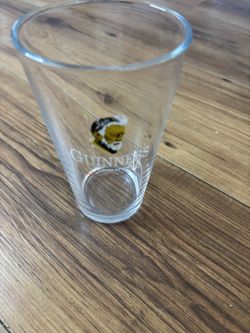 Official Guinness pint glass, featuring the classic logo with the harper graphic
