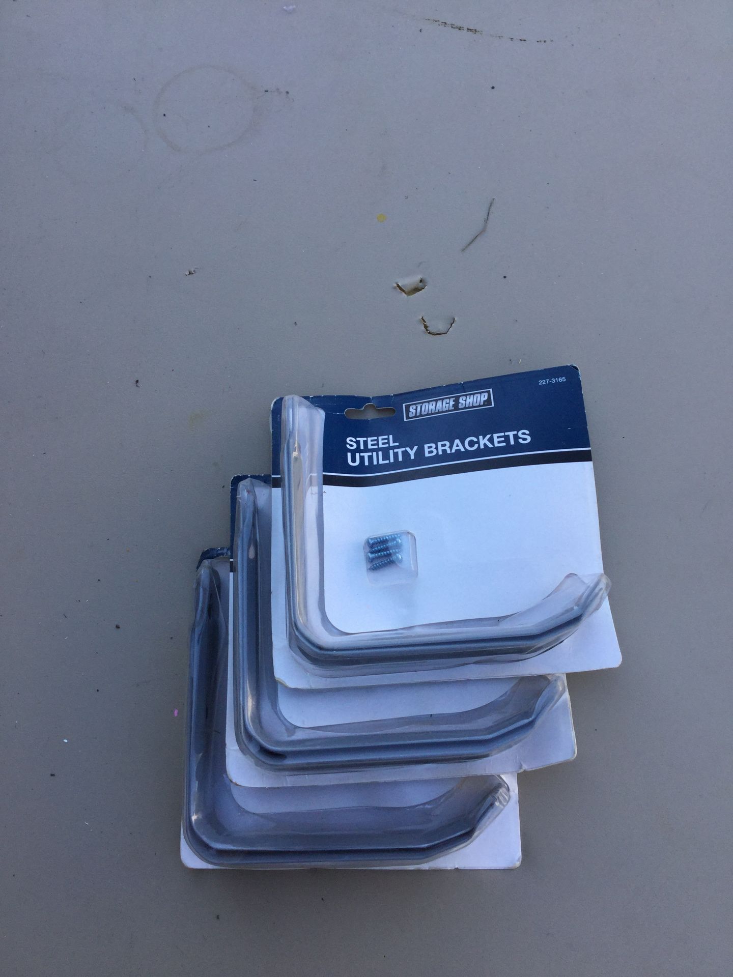 Three sets of metal shelf brackets