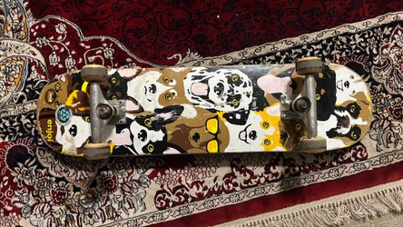 Enjoi Dog Collage Youth complete skateboard featuring a 7.375-inch deck and a colorful graphic of various dog