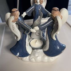 3 angels holdings hand w/tea-light candle