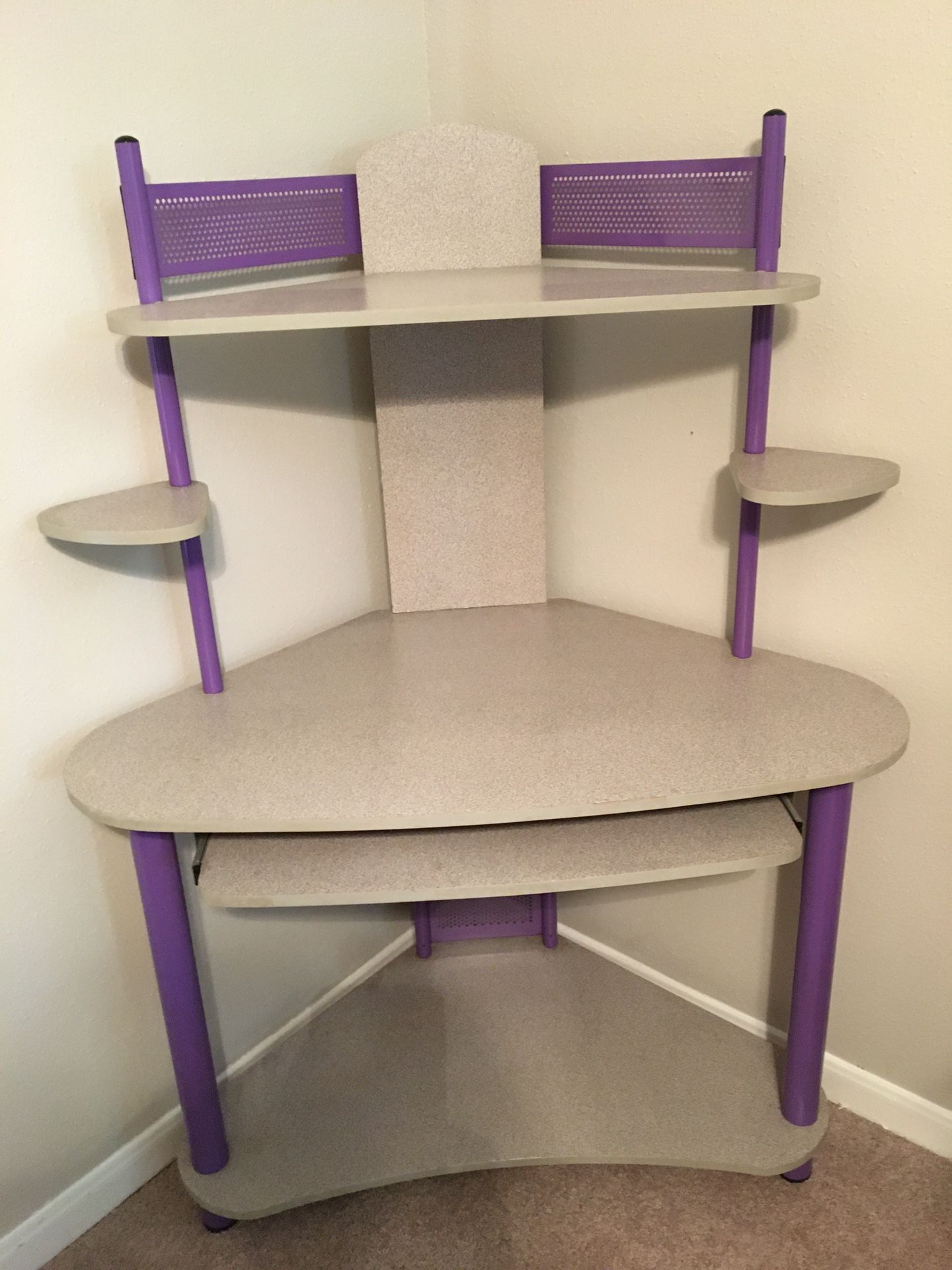 Small corner desk with shelving for peripherals