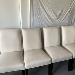 Four Padded Chairs With Slip Covers