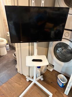 29” Roku TCL tv with rolling stand and remote