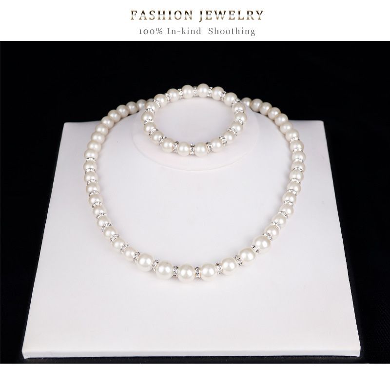 Set of imitation pearls contains (earrings, necklace and bracelet)