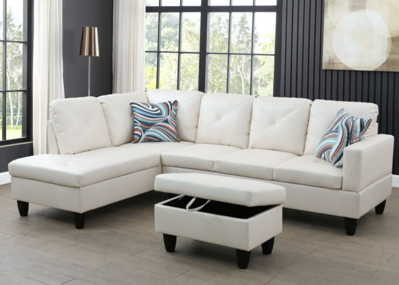 White leather sectional couch and ottoman