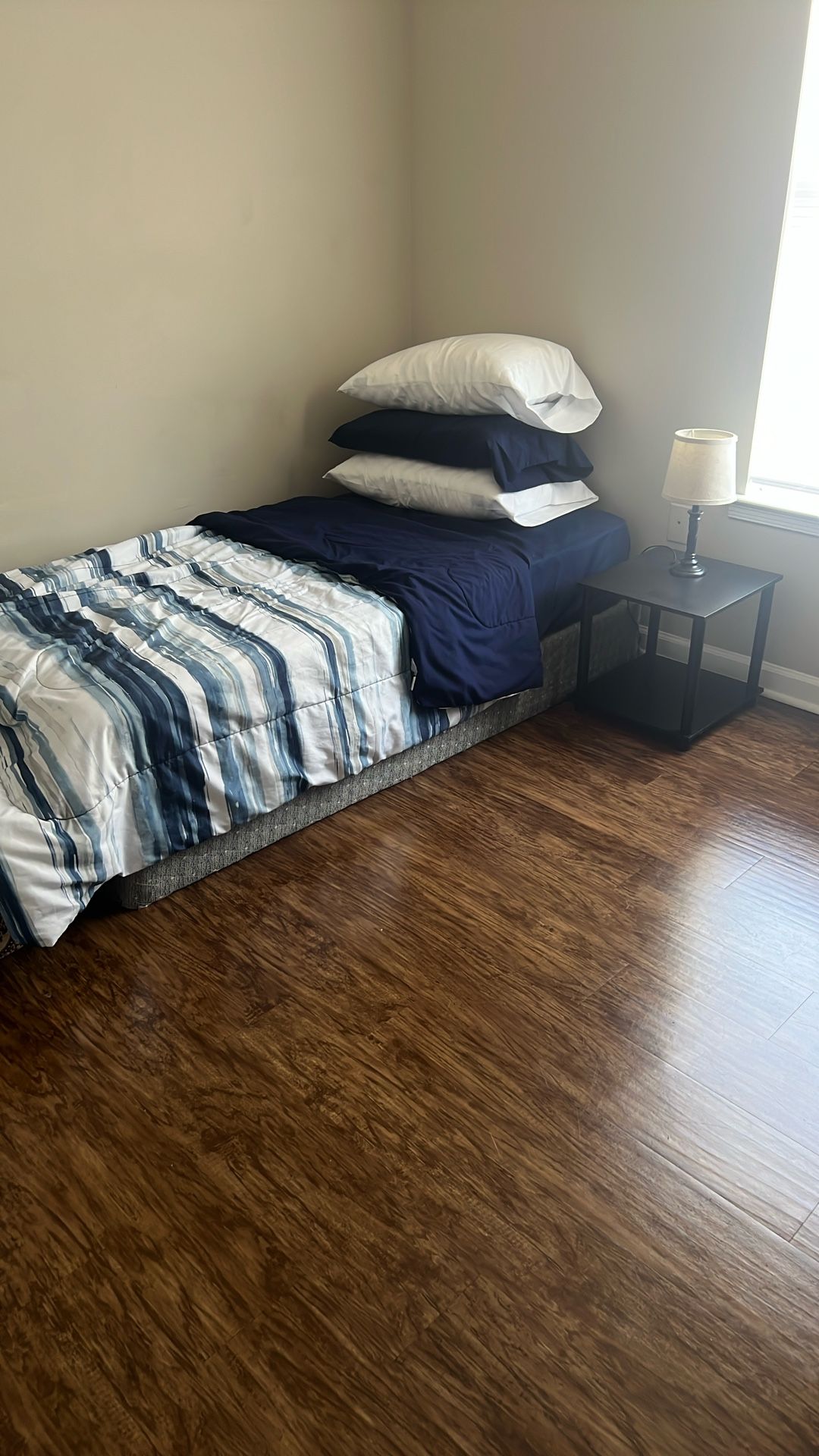 Single Bed Along With Bed Side Table And A Lamp