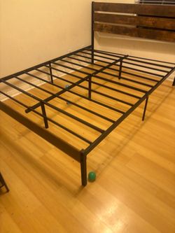 Rustic wood headboard with a modern black metal frame