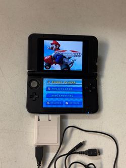 Nintendo 3DS XL SPR-001 console system with charger. No games