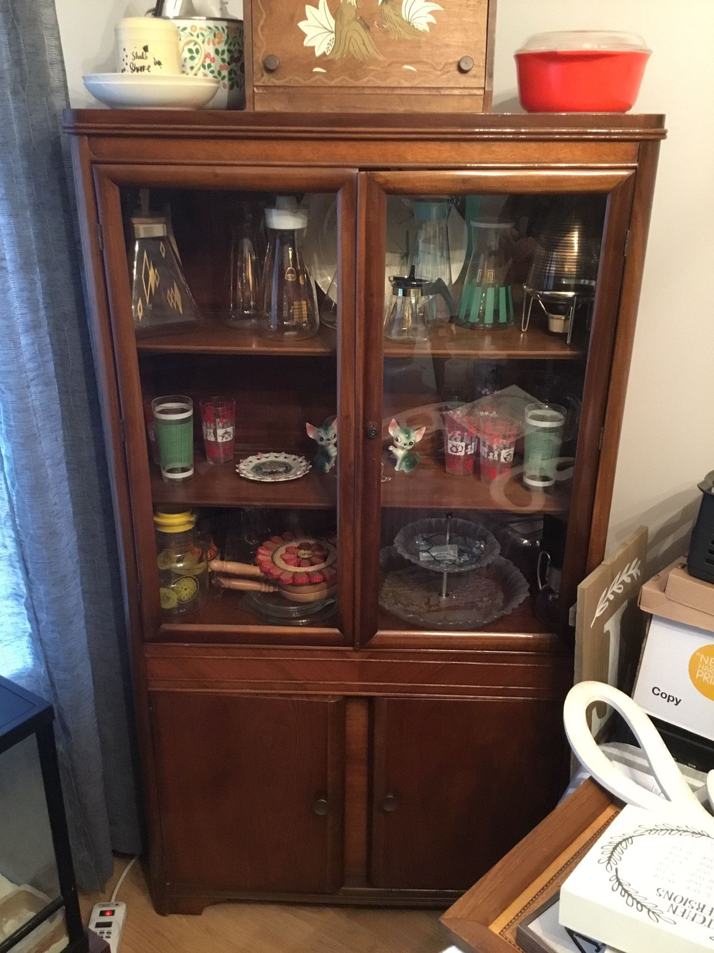 Vintage cabinet stuffed with mid century glassware, vintage chair, platters, carafes.....