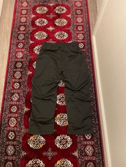 Black sweatpants with Japanese writing and cherry blossom design
