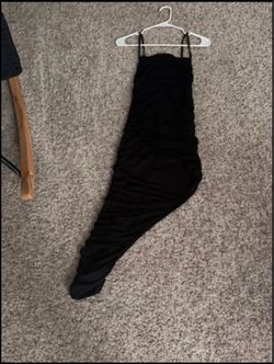Long black dress shows a leg