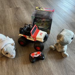 Jada Toys Jurassic Park merchandise, including a remote-control vehicle and plush toys.  Exciting remote control off-road vehicle set featuring plush 