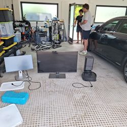 Cleaning Robot, Samsung Flat Screen TV, And DELL Monitor
