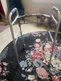 Slightly used silver walker with slide guides for easy use in home