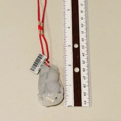 Jade peanut pendant on string necklace