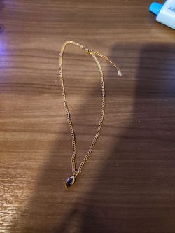Gold necklace with purple stone pendant