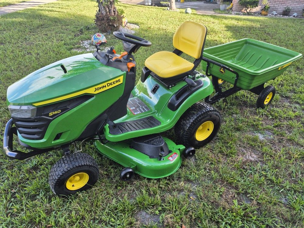 2024 JOHN DEERE S140 22HP 48"CUT W/PULL BEHIND TRAILER
