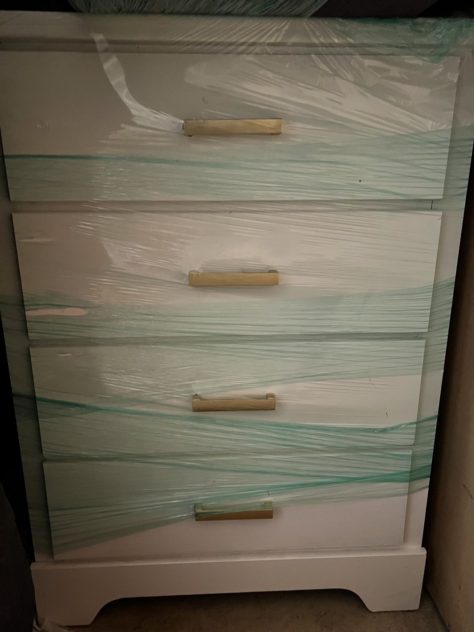 white four-drawer dresser with gold handles