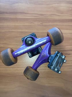 Krux Purple skateboard trucks with wheels