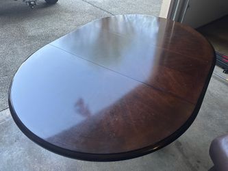 Beautiful, solid wood, dining room table seats six people