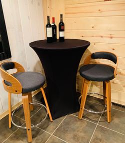 Counter height swivel chairs, 25" H floor to seat, new, never used.  Lovely dark grey fabric, maple colored wood.  Mid Century style.  $80 for the pai