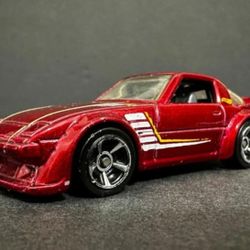 2011 Hot Wheels 31/50 Mazda RX-7 Main Line Edition Red W/ Silver Die-Cast 1:64. The red Hot Wheels Mazda RX-7 in the image was manufactured in the yea