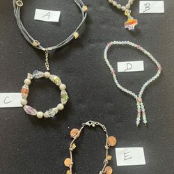 Set of five unique  jewelry pieces including necklaces and bracelets.