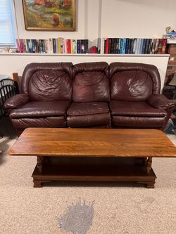 Burgundy Leather 3-Seat Sofa And a solid wood coffee table