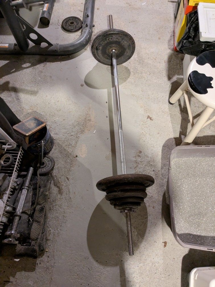 106 Pounds of Standard Weights with a 5 Foot Straight Bar