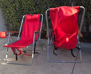 Beach chairs with wood arms and backpack.