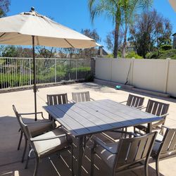 9-piece patio dining set, complete with an umbrella and base