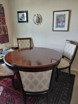 BASSETT 54" round dining table plus an 18" extension. With 4 upholstered chairs.