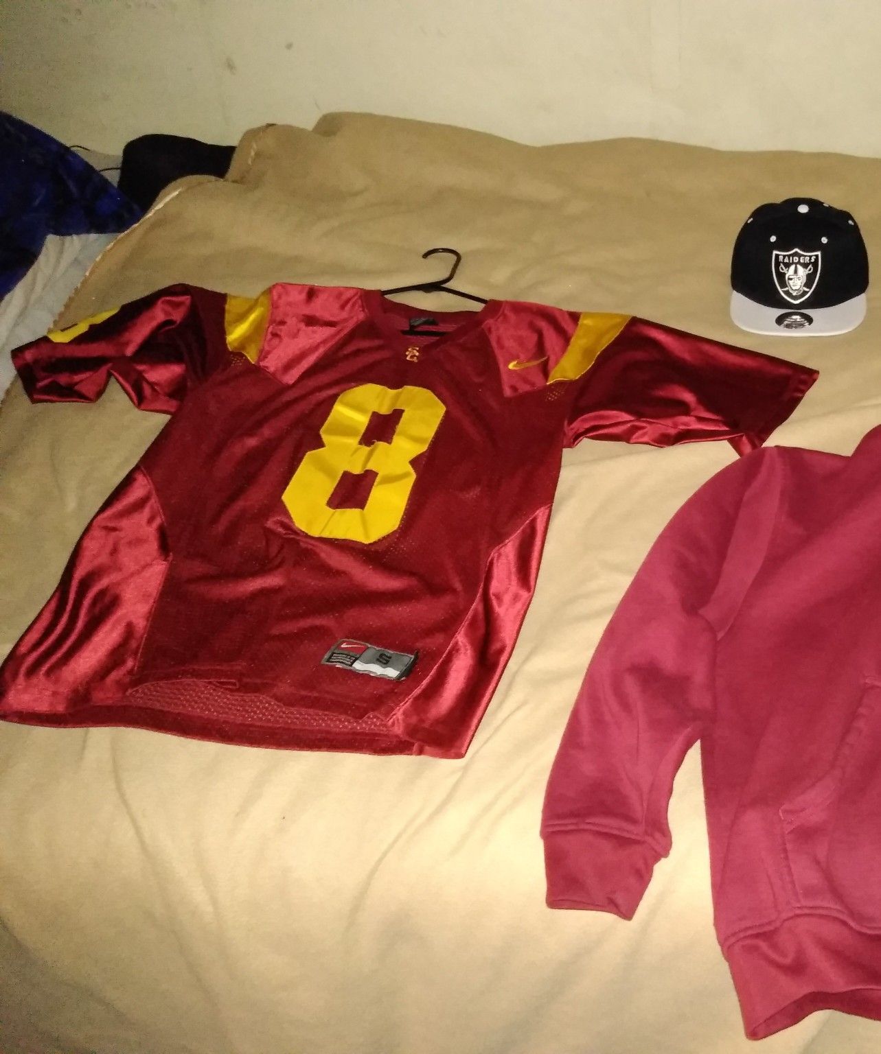 USC football jersey size small and brand new raiders snapback hat