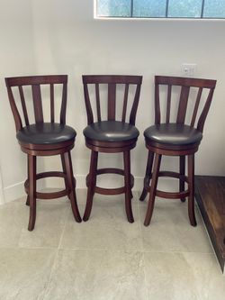 Three swivel bar height barstools