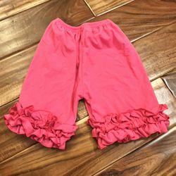 Girl’s pink ruffle icing shorts. Size 6/7