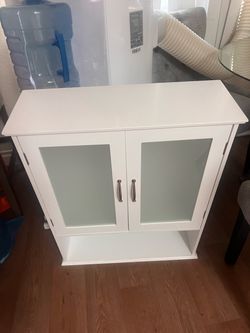 hanging white storage cabinet with frosted glads