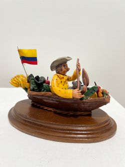 Colombian Folk Art man paddling boat with fruit